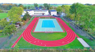 Boisko ze sztuczną nawierzchnią i bieżnia lekkoatletyczna przy szkole w Różannie